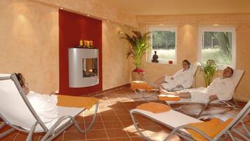 Relax in a serene space with a fireplace and views of the natural landscape.