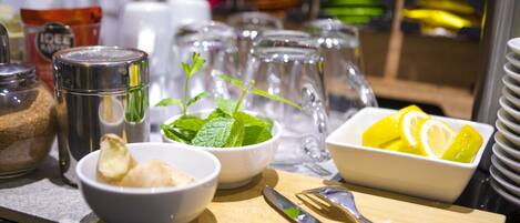 A breakfast setting with bowls of food, utensils, and condiments on a table.