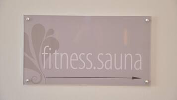 A sign with the text "fitness.sauna" and an arrow pointing to the right.