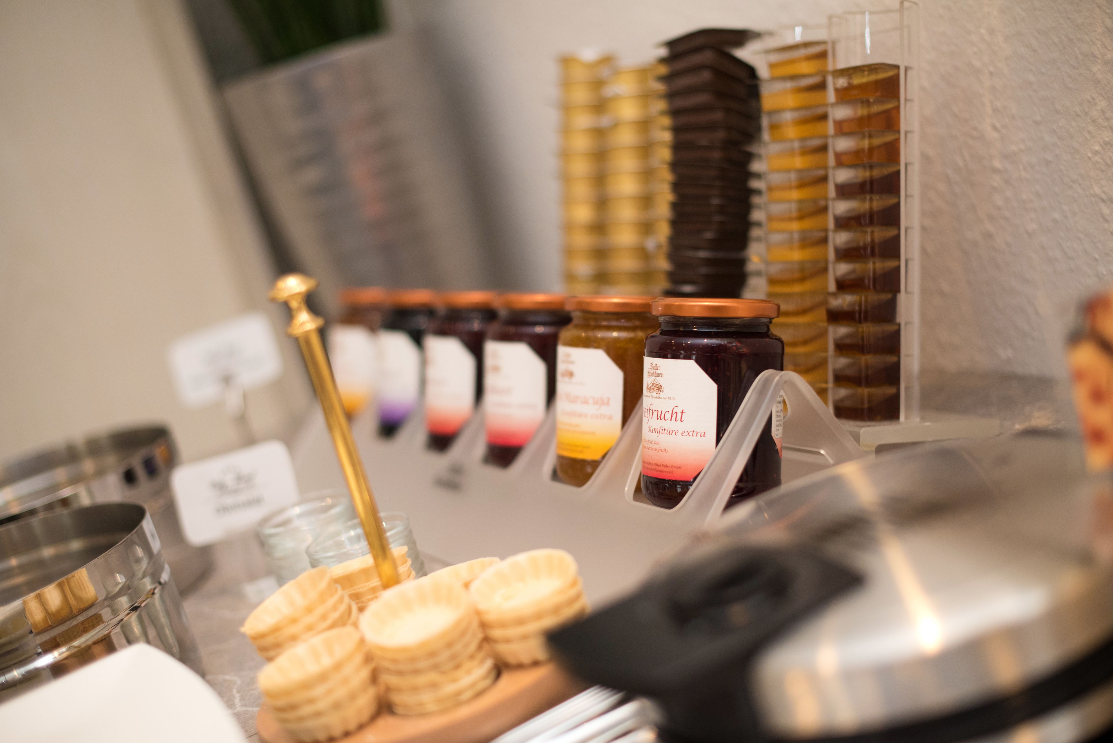 Une exposition de différents pots de miel et de biscuits en forme de rayon de miel.