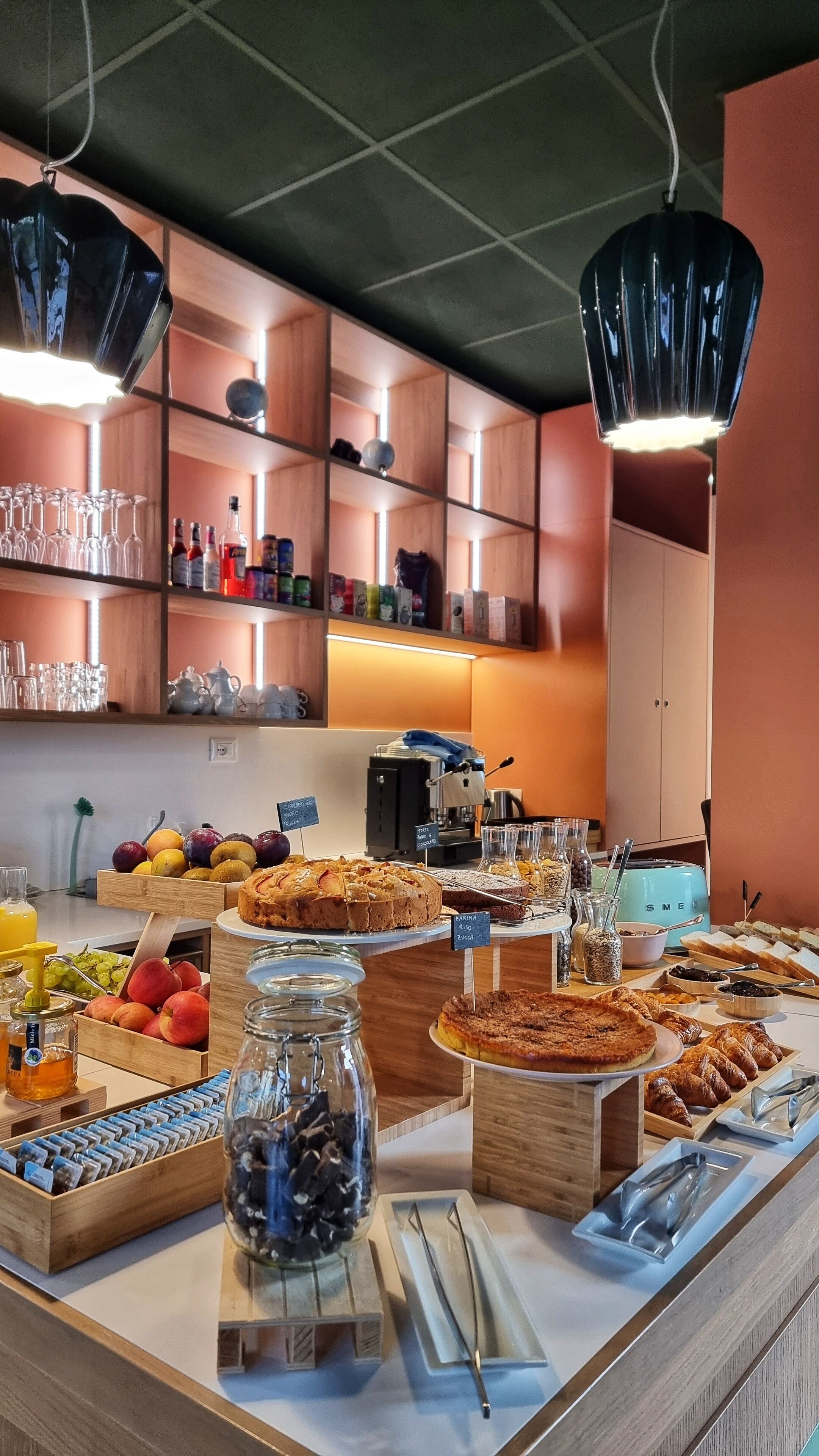 A breakfast buffet with various food items and a coffee machine.