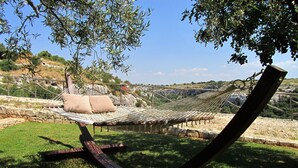 Una hamaca con vista a un paisaje rocoso y árboles.