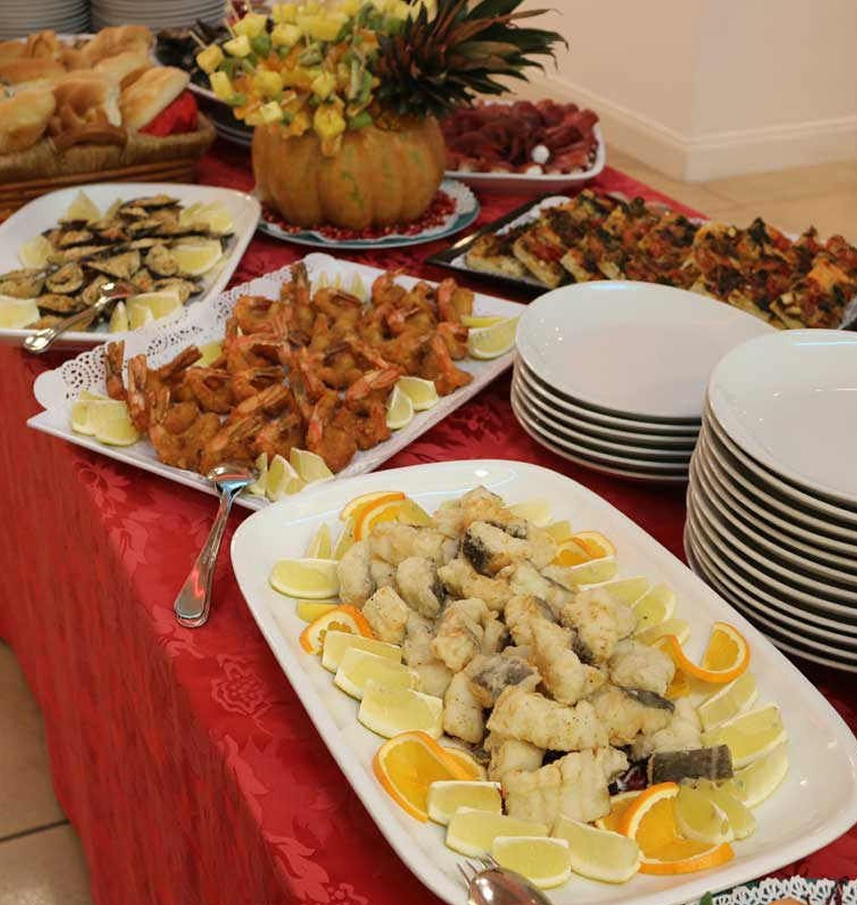 A buffet table with various dishes including seafood, salads, and bread.