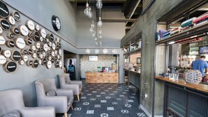 A modern interior with a reception desk, seating area, and a bar. - Yunus Beach Hotel (Marmaris)