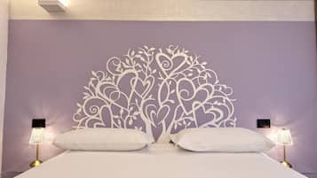 A bedroom with a decorative headboard, two bedside lamps, and a bed with white bedding.