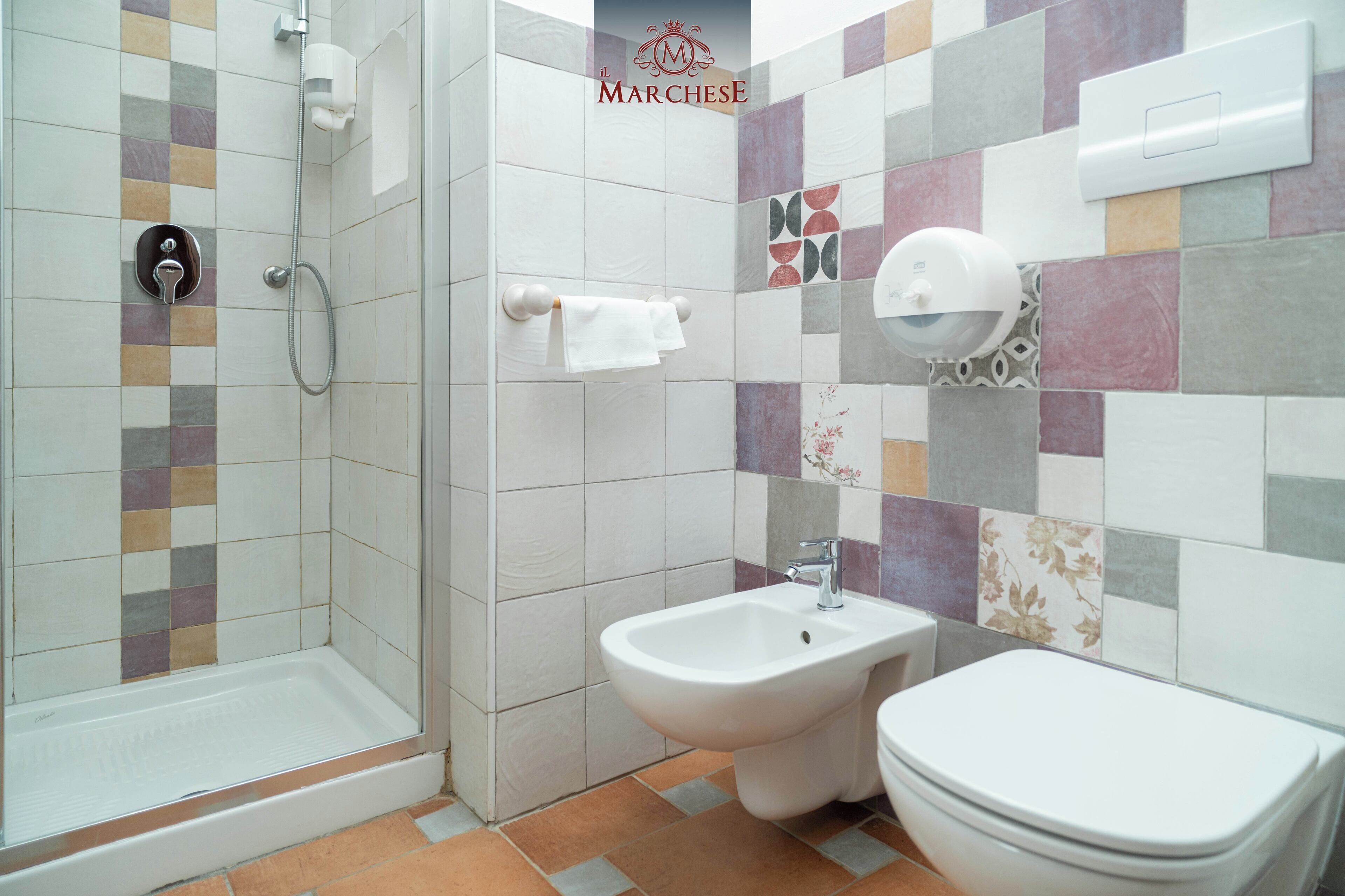 Ein Badezimmer mit Dusche, Bidet und Toilette.
