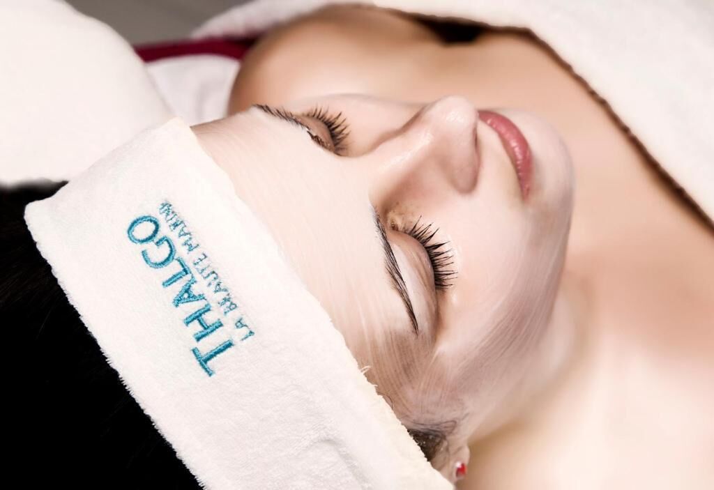 A person with a towel over their head, suggesting a spa or relaxation setting.