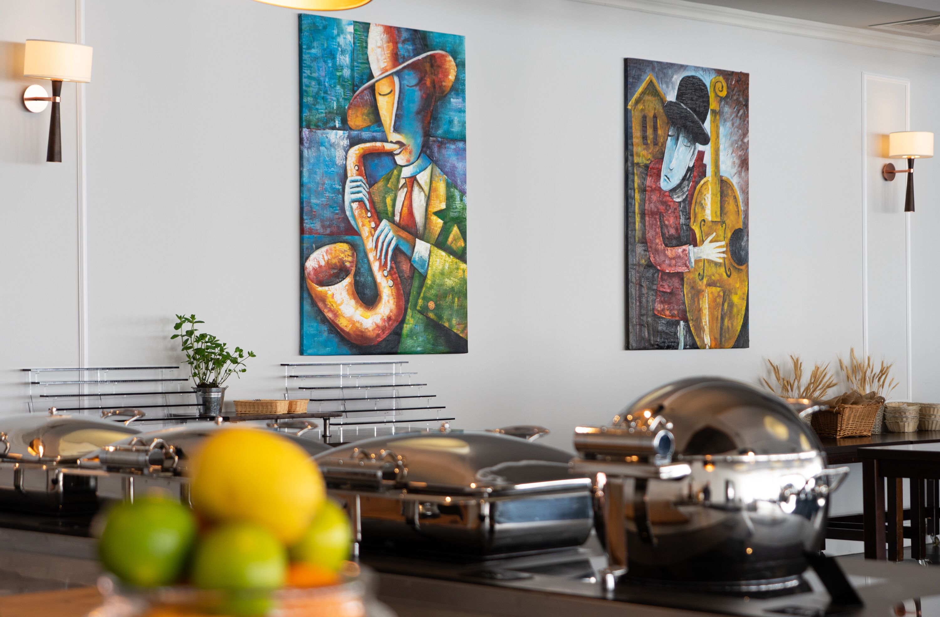 A dining area with a buffet setup, including a variety of dishes and a piano.