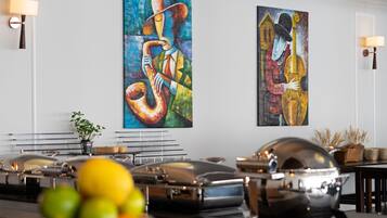 A dining area with a buffet setup, including a variety of dishes and a piano.