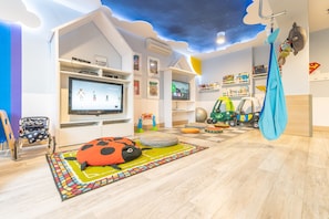 A children's playroom with a TV, toys, and a ceiling mural. - Marena Wellness & Spa (Dziwnów)