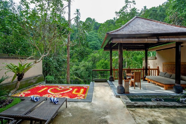 A covered outdoor seating area with a wooden table and chairs, a small pool, and a decorative tile design on the ground. - The Lokha Ubud Resort, Villas & SPA (Ubud)