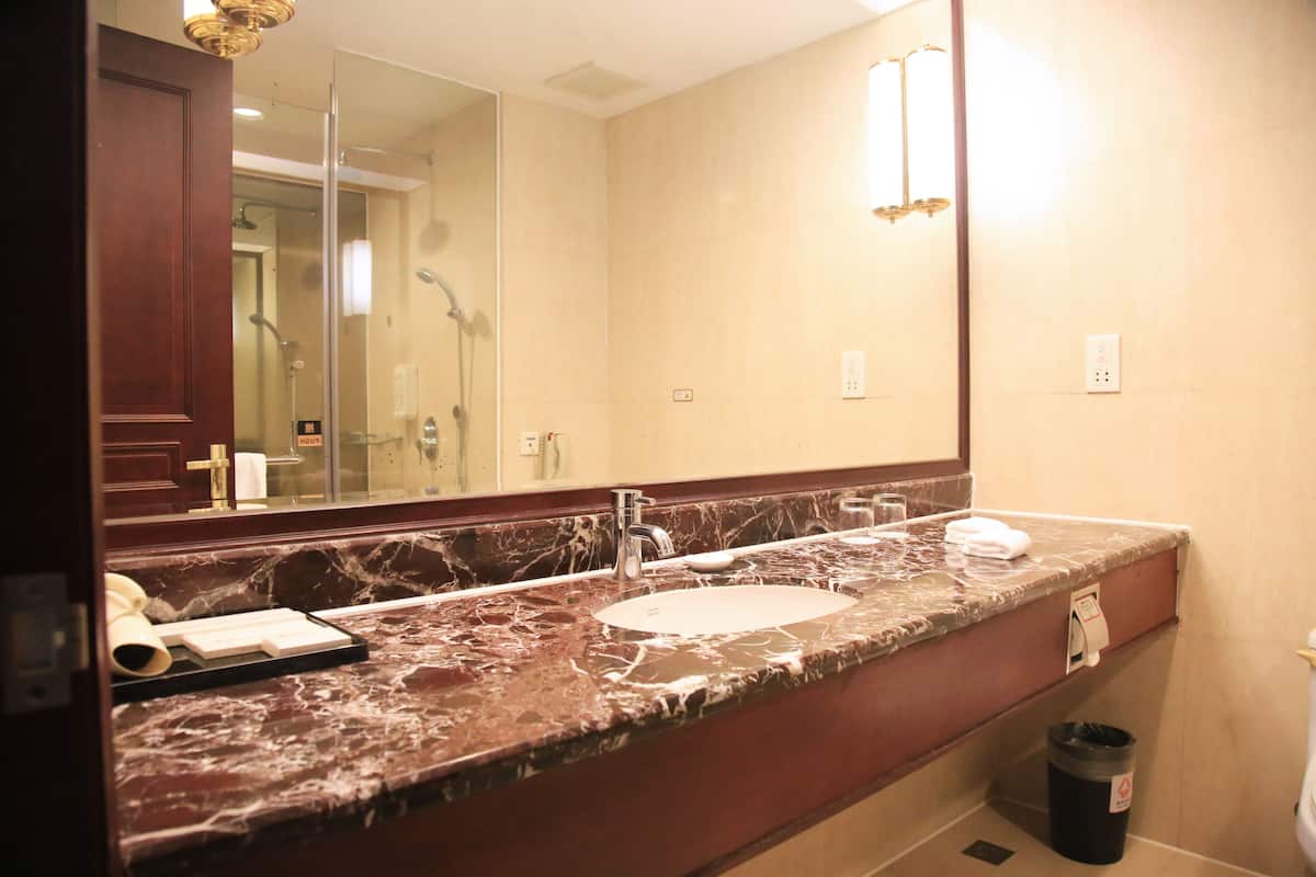 superior twin room | bathroom | shower, hair dryer, slippers, towels
