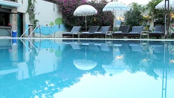 Outdoor pool, open 9 AM to 6 PM, pool loungers