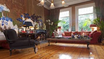A cozy living room with a fireplace, a comfortable sofa, and a coffee table.