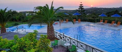 Indoor pool, outdoor pool, pool umbrellas, pool loungers