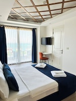 Deluxe Room, Sea View | Minibar, in-room safe, desk, blackout drapes