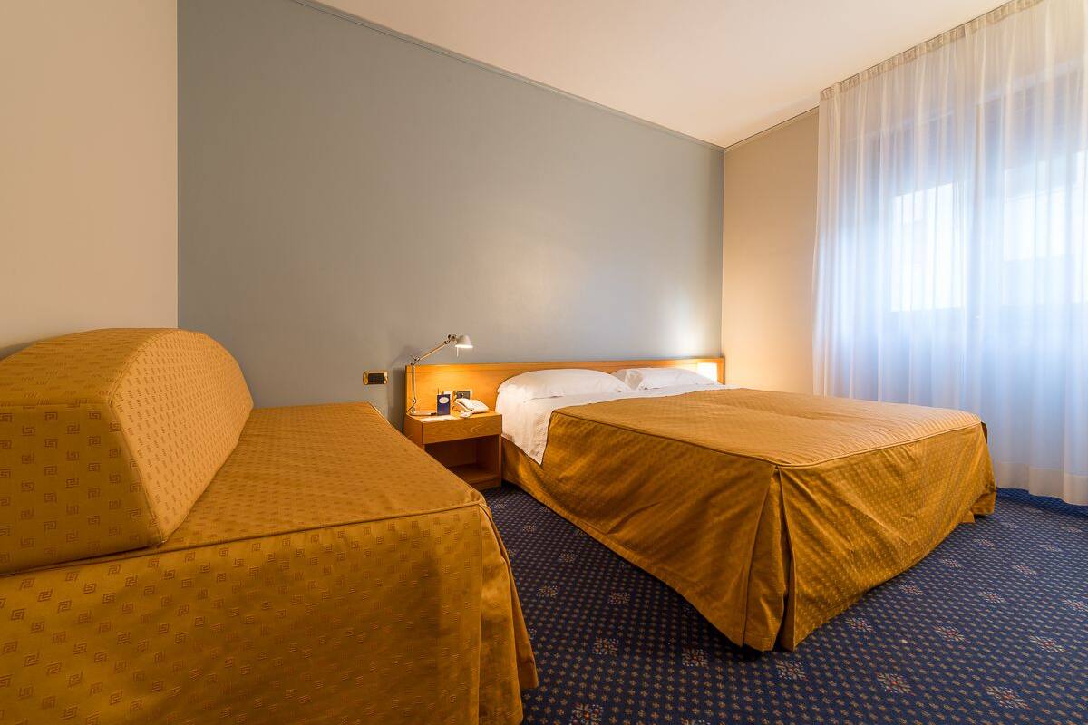 Standard Triple Room | Minibar, in-room safe, desk, iron/ironing board