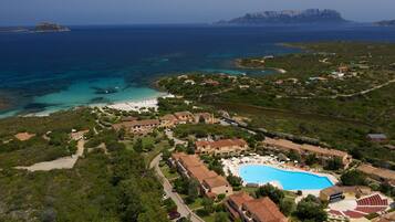 Relax by the pool surrounded by lush greenery and enjoy access to the ocean views.
