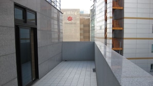 A modern building with a tiled floor and a glass door. - Laketel (Seoul)
