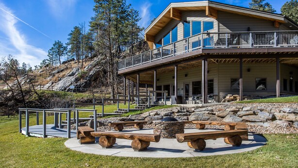 A modern lodge with a large deck, stone fire pit, and picnic tables. - K Bar S Lodge, an Ascend Collection Hotel (Keystone)