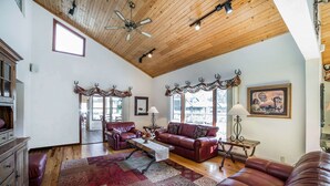 A spacious living room with leather sofas, a wooden ceiling, and a large rug. - K Bar S Lodge, an Ascend Collection Hotel (Keystone)