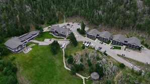 A lodge with multiple buildings, parking areas, and a surrounding forest. - K Bar S Lodge, an Ascend Collection Hotel (Keystone)
