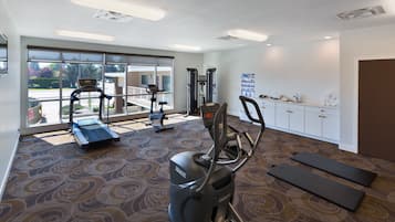 A gym with treadmills, elliptical machines, and weight equipment.