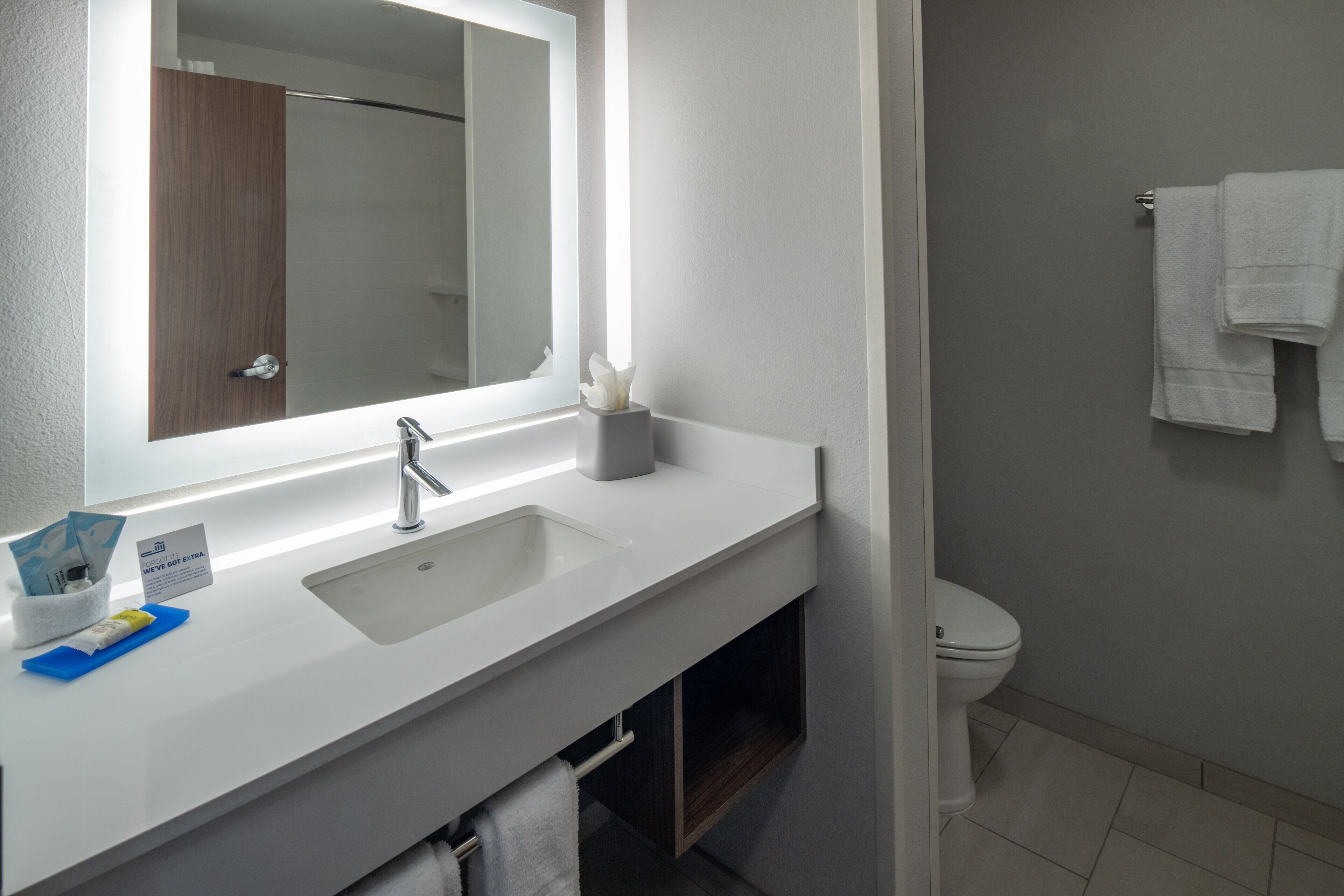 designer toiletries, hair dryer, towels, soap