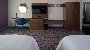 A hotel room with a bed, a desk with a chair, a TV, and a wardrobe. - Holiday Inn Express and Suites Little Rock Downtown by IHG (Little Rock)