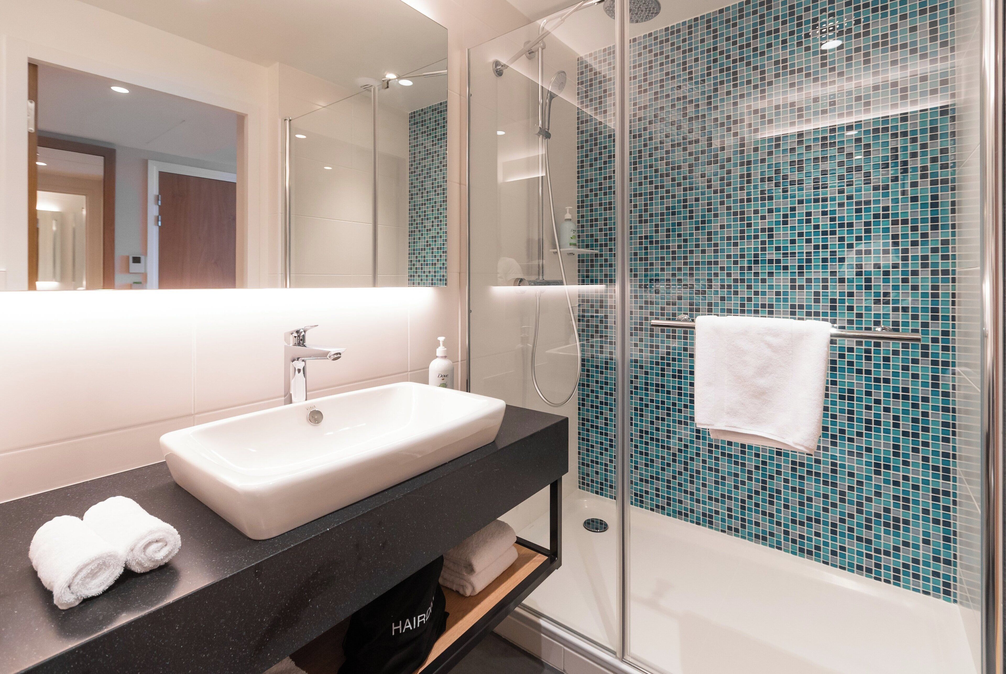 rainfall showerhead, eco-friendly toiletries, towels