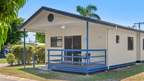 A small, single-story building with a covered porch and a small table and chairs. - Discovery Parks - Ayr (Ayr)