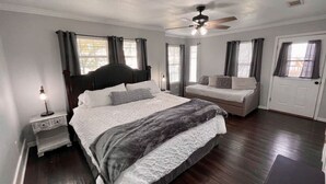 A bedroom with a large bed, a nightstand, a dresser, a ceiling fan, and a window with curtains. - ❤️ Wide Open Water!  Huge Boat Dock w/ rope swing!  Lake toys (Kayak, Paddleboard, Lily Pad) included!  Great fishing!  🐟 (Gun Barrel City)
