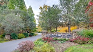 A landscaped entrance with a stone sign reading "Mountainview." - Hike & Ski: Mtn-View Gem w/ Balcony in Burnsville! (Burnsville)