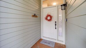 A white door with a wreath, a welcome sign, and a doormat. - Hike & Ski: Mtn-View Gem w/ Balcony in Burnsville! (Burnsville)