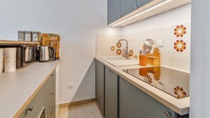 A modern kitchen with a countertop, sink, and cabinets.