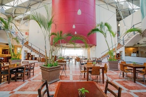 Relax in our spacious atrium, surrounded by lush greenery and a striking central feature.