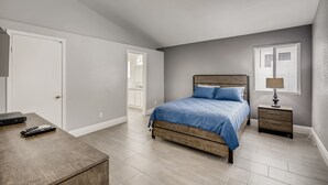 A bedroom with a bed, bedside table, and a lamp. - The Best House With A Heated Pool, Spa, and Safe, Sleeps 6 Comfortably (North Las Vegas)