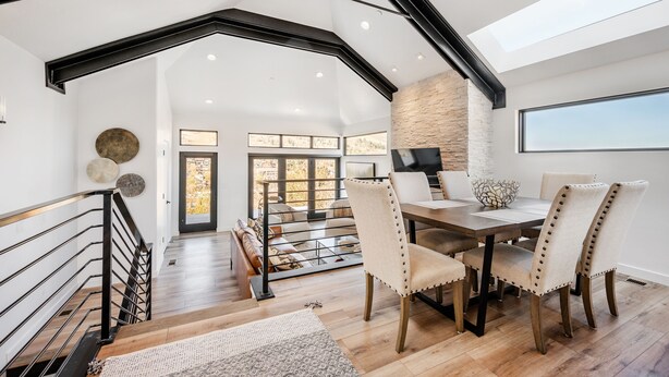 A spacious dining area with a high ceiling, wooden flooring, and a modern chandelier. - Luxury in Old Town, Walk to Main St. and Town Lift, Forever Views!

 (Park City)