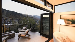 A balcony with a view of a mountainous landscape, a sofa, and a table with a lamp. - Luxury in Old Town, Walk to Main St. and Town Lift, Forever Views!

 (Park City)