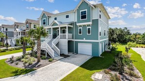 A two-story residential building with a front porch, a garage, and a well-maintained lawn. - Winter Monthly Available | Golf Cart Included | Pet Friendly | Beach Club | Free Golf |Pools |Tennis (Pensacola)