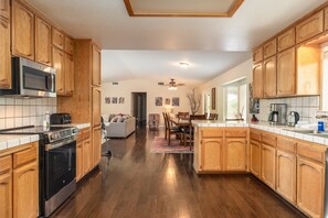 Enjoy cooking in this well-equipped kitchen with a large island, sink, and microwave.