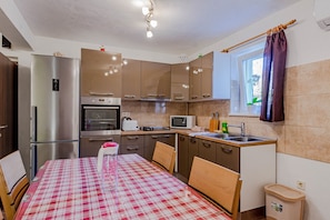 Apartment, 1 Queen Bed with Sofa bed | Private kitchen | Fridge, microwave, oven, stovetop