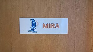 A nameplate with the name "MIRA" and a logo on a wooden surface. - Room Mira With Terrace and sea View (Omisalj)