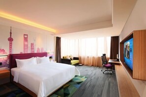 A hotel room with a large bed, a desk with a chair, a flat-screen TV, and a cityscape mural on the wall. - Hampton BY Hilton Shanghai Hongqiao Necc (Shanghai)