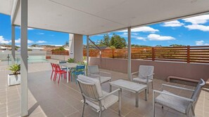 Relax in a serene outdoor space with a view of the surrounding landscape, perfect for dining or unwinding.