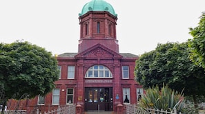 A red brick building with a green dome roof, labeled "City of Westminster Museum."