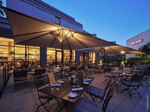 Enjoy al fresco dining under shaded umbrellas in our outdoor dining area.