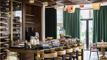 A bar area with a wine rack, seating, and a buffet.