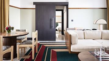 Junior Suite | Living area | 65-inch Smart TV with cable channels, TV, pay films