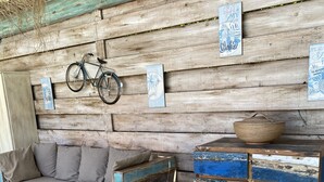 A rustic wooden room with a sofa, a bench, and a multi-compartment chest of drawers. - Superb 250 m2 Provencal farmhouse for rent (Mas-Blanc-des-Alpilles)
